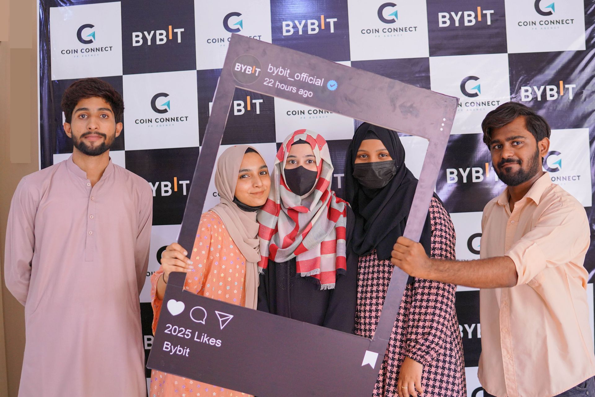 Karachi Hackathon 2025 stage with Bybit 'Growing — The Future of Tomorrow' branded pull-up banner — speaker presenting to participants on a professional stage with bitcoin and dollar coin graphics, organized by CoinConnect for Bybit